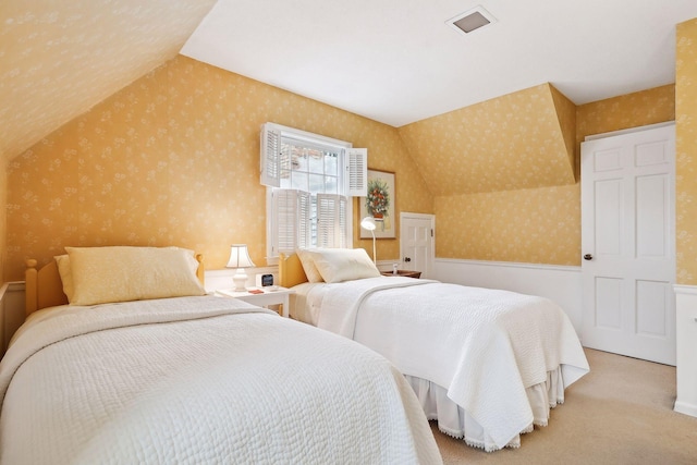 carpeted bedroom with vaulted ceiling