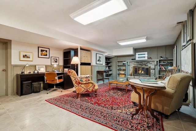 living room with a stone fireplace