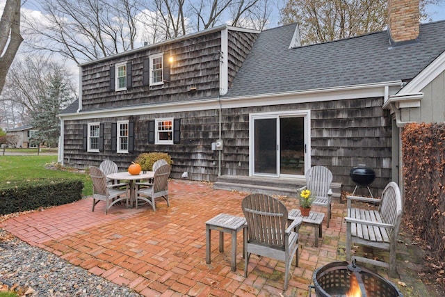 back of house featuring a patio area and a fire pit