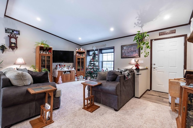 living room with light hardwood / wood-style floors, vaulted ceiling, and ornamental molding