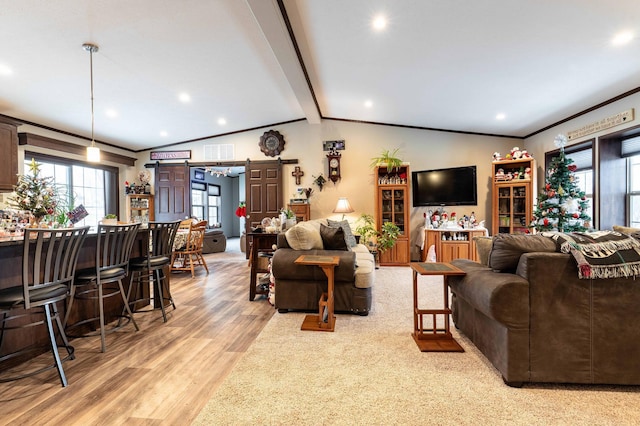 living room featuring vaulted ceiling with beams, light hardwood / wood-style floors, crown molding, and indoor bar