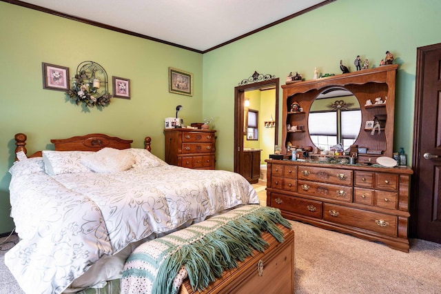 bedroom with light carpet, ensuite bath, and ornamental molding