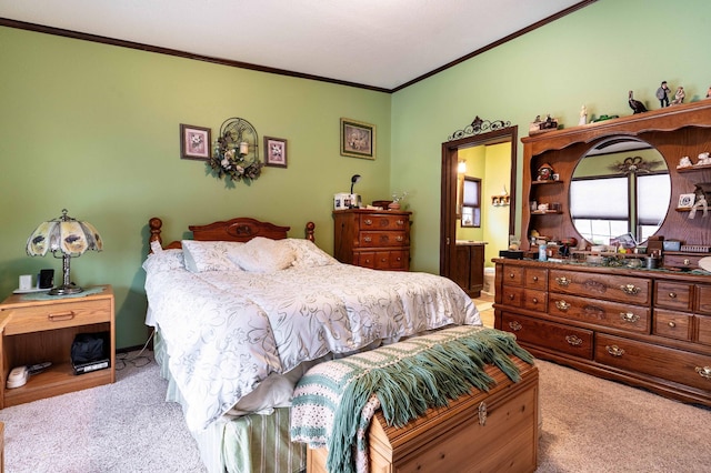 carpeted bedroom featuring ensuite bathroom and ornamental molding