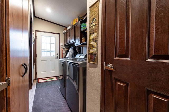 laundry room featuring cabinets, washer and clothes dryer, and ornamental molding