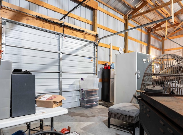 garage with stainless steel refrigerator