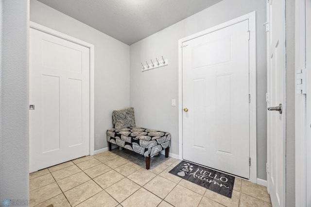 tiled foyer entrance with a textured ceiling