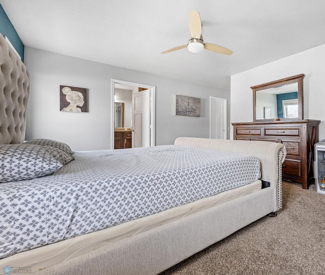 carpeted bedroom featuring ensuite bathroom and ceiling fan