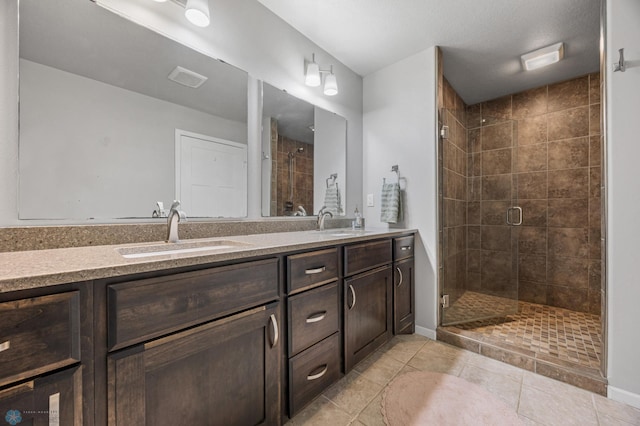 bathroom featuring tile patterned floors, vanity, and a shower with shower door