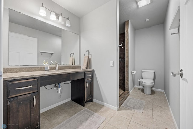 bathroom featuring tile patterned flooring, a textured ceiling, toilet, tiled shower, and vanity