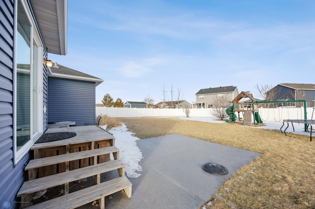 view of yard featuring a playground and a patio