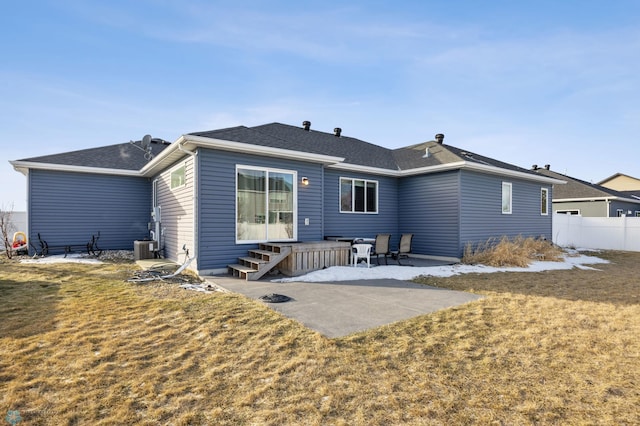 rear view of property featuring a yard, a patio, and central AC unit