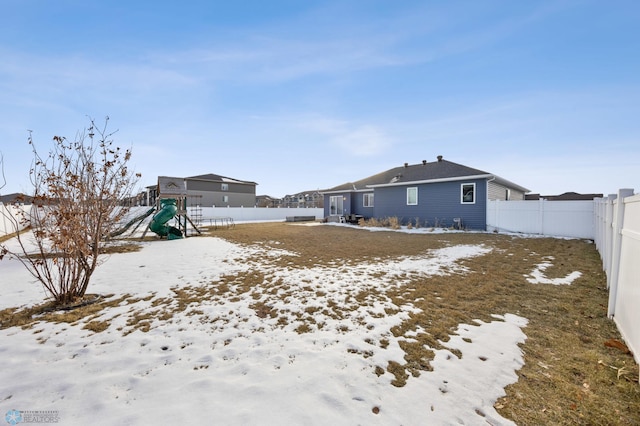 snowy yard with a playground