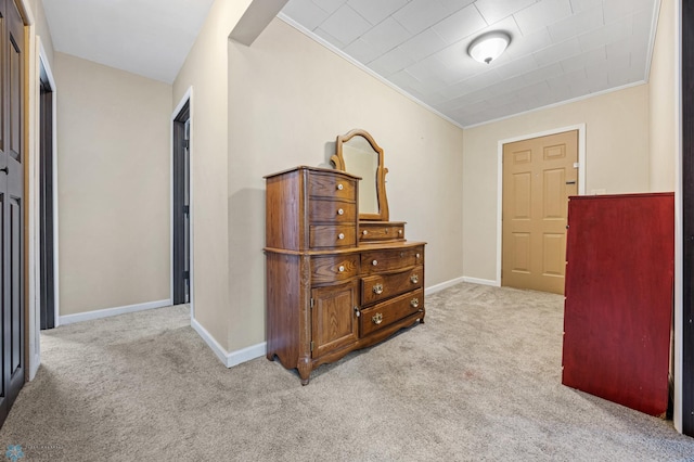 hall with light carpet and crown molding