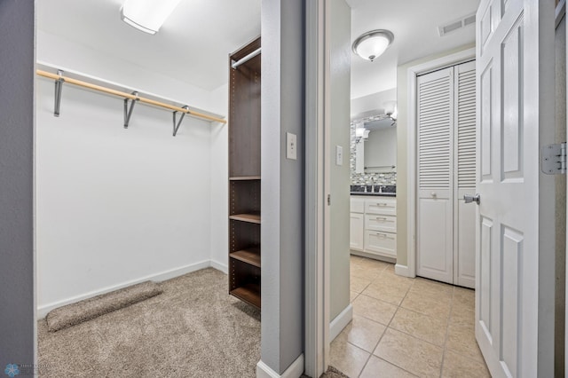 spacious closet with light tile patterned flooring