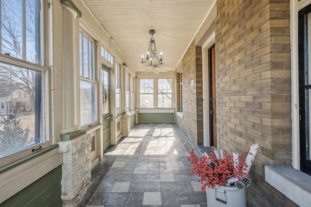 unfurnished sunroom with a chandelier