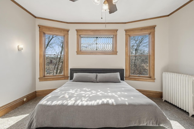 carpeted bedroom featuring radiator, ornamental molding, and ceiling fan