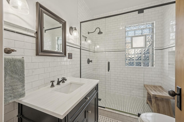 bathroom featuring tile walls, vanity, and an enclosed shower