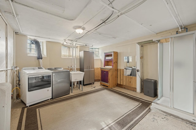 basement featuring washer and clothes dryer and sink