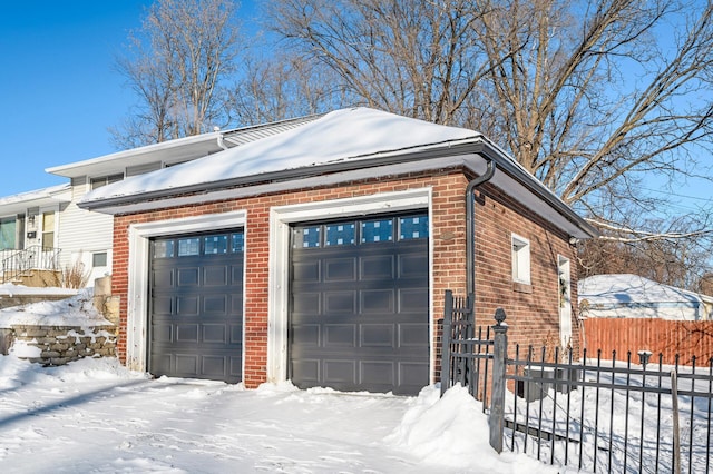 view of snowy exterior featuring a garage