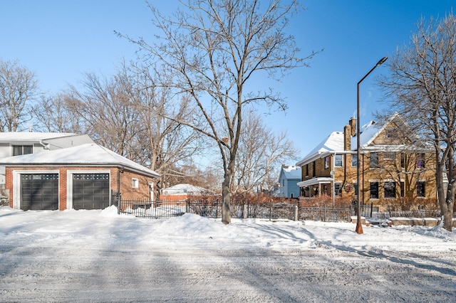 snowy yard featuring a garage