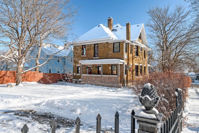 snow covered property with a porch