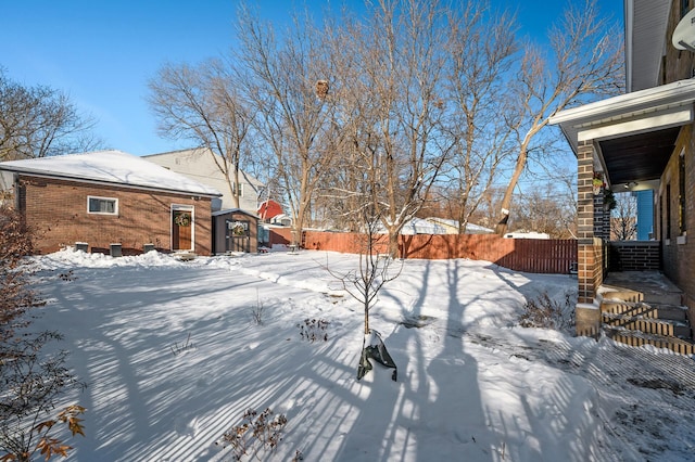 view of yard layered in snow