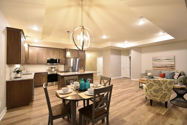 106 Fairway St, Zumbrota, MN 55992 - dining space with a raised ceiling, baseboards, light wood-style flooring, a chandelier, and recessed lighting