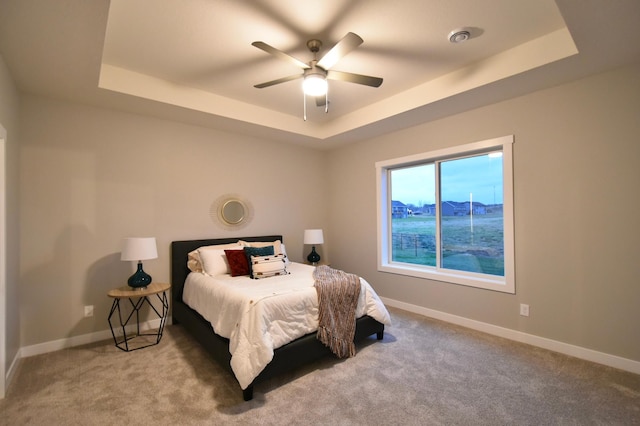 106 Fairway St, Zumbrota, MN 55992 - carpeted bedroom featuring a raised ceiling, baseboards, and ceiling fan