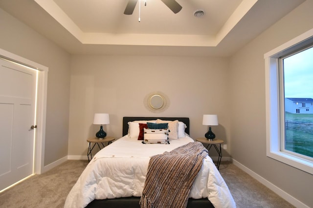 106 Fairway St, Zumbrota, MN 55992 - carpeted bedroom featuring a raised ceiling, baseboards, and a ceiling fan