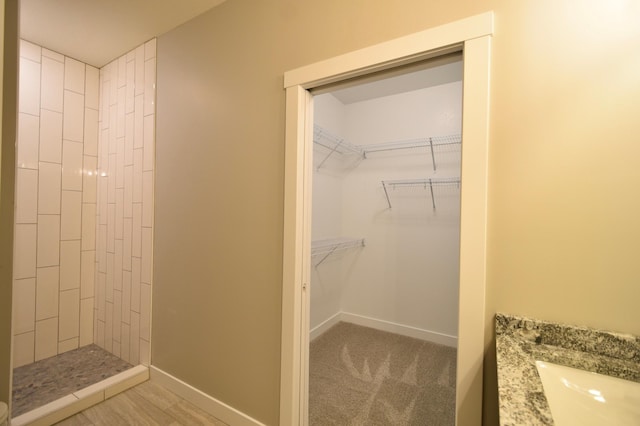 106 Fairway St, Zumbrota, MN 55992 - full bath featuring a tile shower, vanity, and baseboards