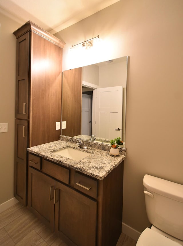 106 Fairway St, Zumbrota, MN 55992 - bathroom with vanity, toilet, baseboards, and wood finished floors