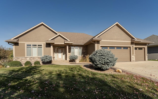 craftsman-style home featuring a front lawn and a garage