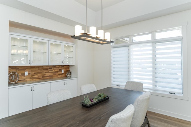 dining room featuring dark wood-type flooring and a notable chandelier