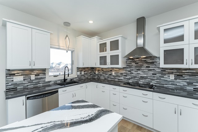 kitchen with white cabinets, dishwasher, wall chimney exhaust hood, and decorative light fixtures