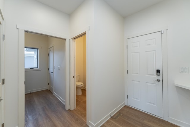 corridor featuring dark wood-type flooring