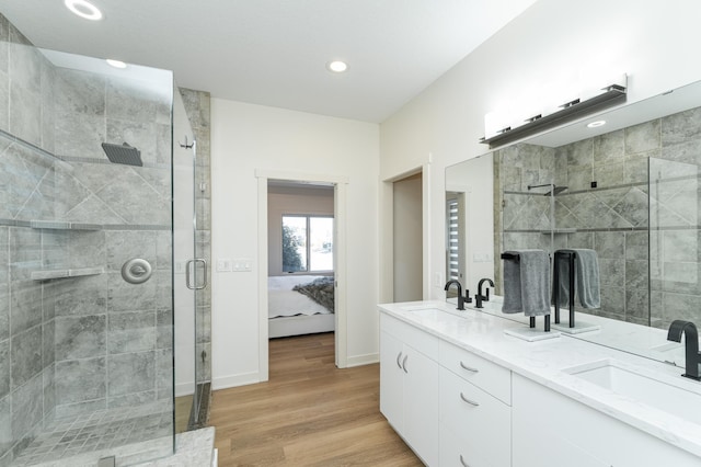 bathroom with wood-type flooring, vanity, and walk in shower