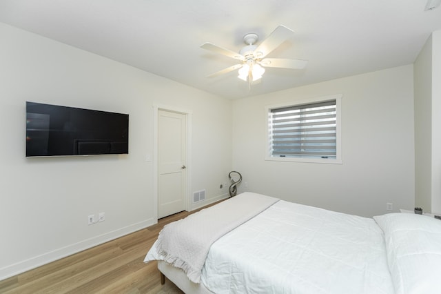 bedroom with ceiling fan and light hardwood / wood-style flooring