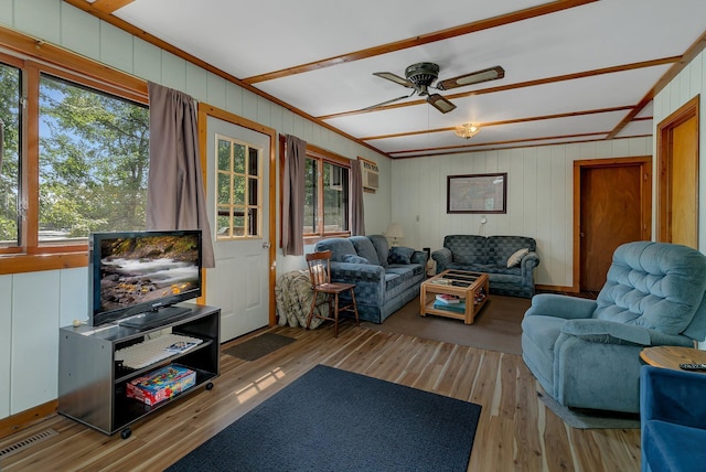 living room with ceiling fan, visible vents, and wood finished floors