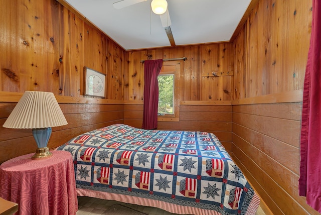 bedroom featuring wooden walls and ceiling fan