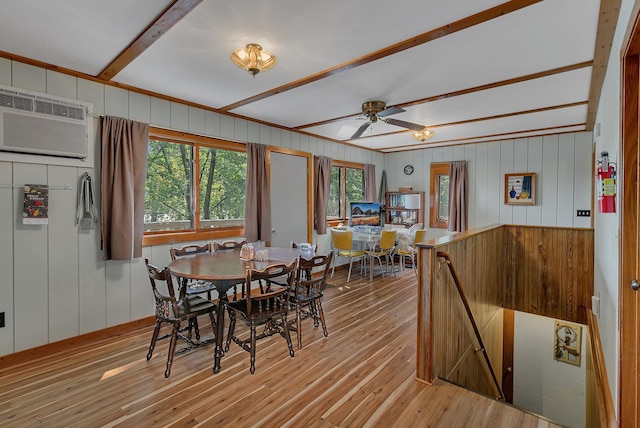 dining room with a ceiling fan, light wood-type flooring, and a wall mounted air conditioner