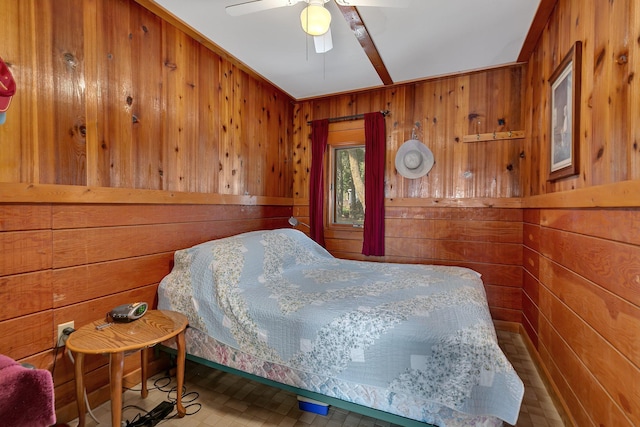 bedroom with wooden walls and ceiling fan