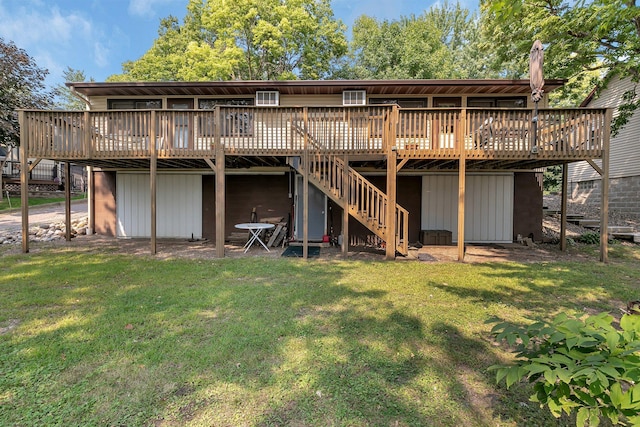 rear view of property with stairway, a yard, and a wooden deck