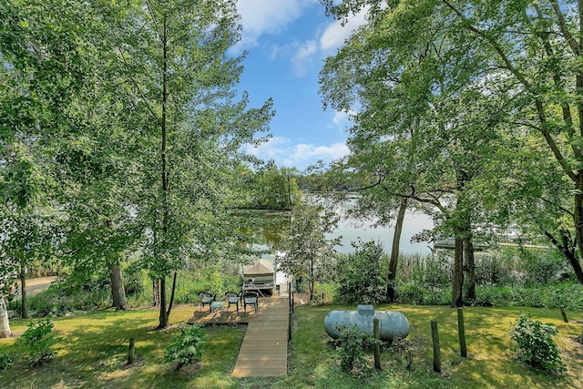 view of dock with a lawn