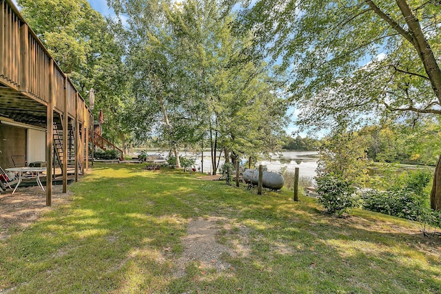 view of yard with a water view and stairs