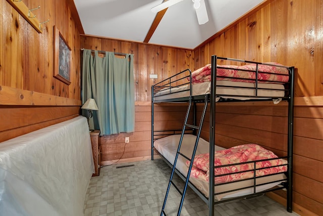 bedroom with tile patterned floors, wooden walls, and visible vents