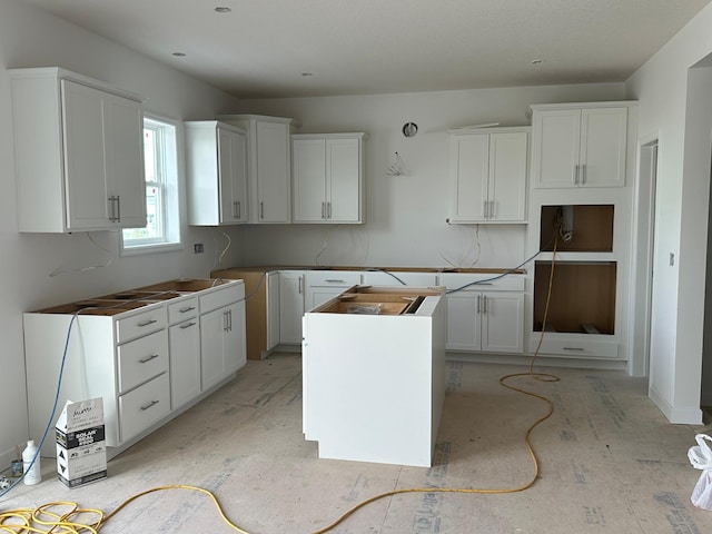 kitchen featuring a center island and white cabinets