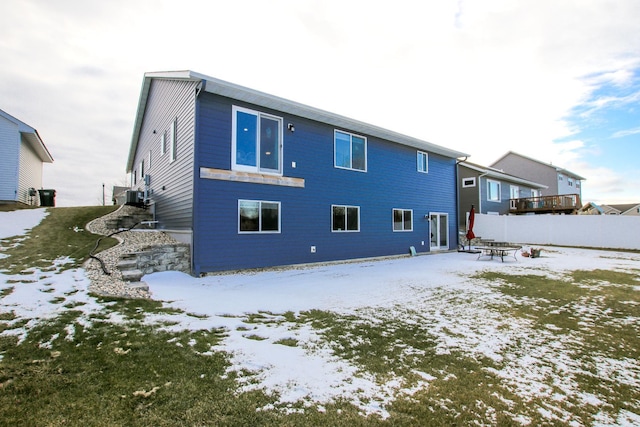 view of snow covered rear of property