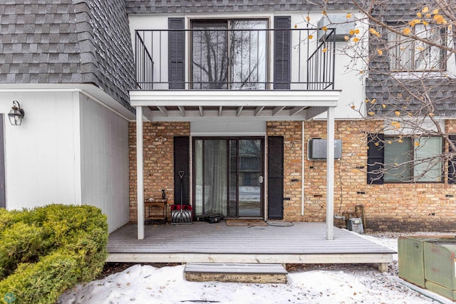 view of exterior entry featuring a balcony