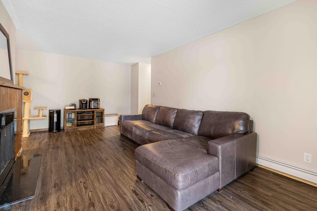 living room featuring dark hardwood / wood-style floors, a textured ceiling, and a baseboard radiator