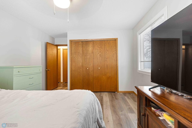 bedroom with light wood-type flooring and a closet